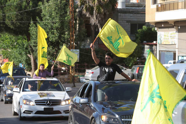  Supporters of Lebanon's Hezbollah leader Sayyed Hassan Nasrallah, carry flags as they ride in a convoy, marking the commemoration of Israel's withdrawal from southern Lebanon in 2000, in Houla village, near the border with Israel, southern Lebanon, May 25, 2023 (photo credit: REUTERS/AZIZ TAHER)