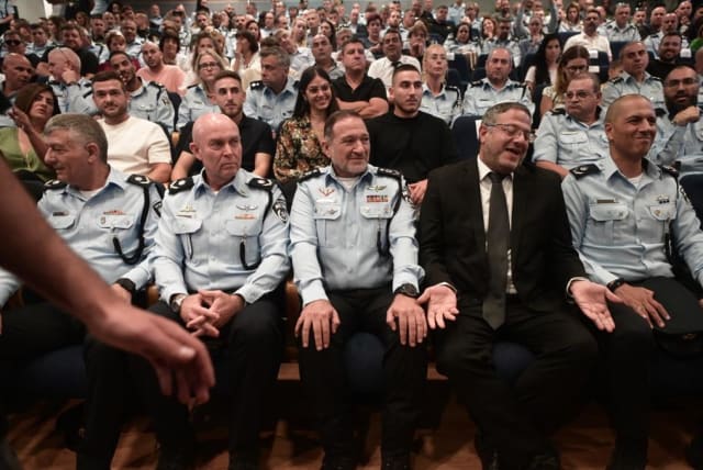  Police chief Kobi Shabtai and a shrugging National Security Minister Itamar Ben-Gvir are seen at the Tel Aviv police district chief departure ceremony on July 19, 2023 (photo credit: AVSHALOM SASSONI/MAARIV)