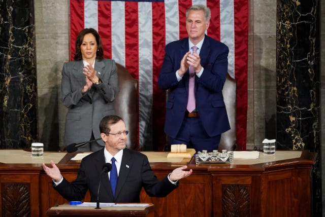  Israeli President Isaac Herzog gestures as U.S. Vice President Kamala Harris and U.S. House Speaker Kevin McCarthy (R-CA) applaud on the day of Herzog's address to a joint meeting of Congress inside the House Chamber of the U.S. Capitol in Washington, U.S., July 19, 2023. (photo credit: REUTERS/KEVIN LAMARQUE)