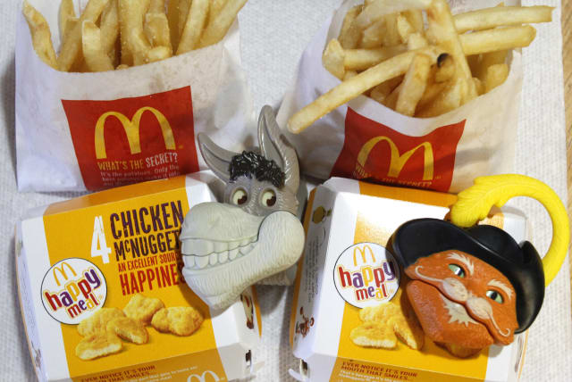 Two McDonald's Happy Meal with toy watches fashioned after the characters Donkey and Puss in Boots from the movie "Shrek Forever After" are pictured in Los Angeles (photo credit: MARIO ANZUONI/REUTERS)
