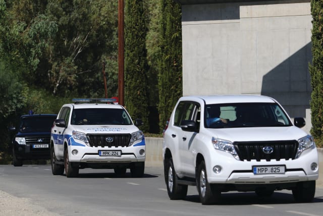  POLICE VEHICLES leave a court, where a remand order was issued against a man suspected of plotting to murder Israeli businesspeople, in Nicosia, 2021. (photo credit: YIANNIS KOURTOGLOU/REUTERS)