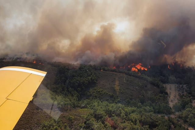  A Turkish firefighting plane flies over a wildfire burning on the island of Rhodes, Greece, July 24, 2023. (photo credit: Turkish Ministry of Agriculture and Forestry/Handout via REUTERS)
