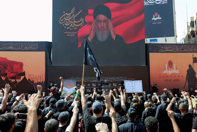 Lebanon's Hezbollah leader Sayyed Hassan Nasrallah addresses his supporters through a screen during a religious ceremony to mark Ashura in Beirut's southern suburbs, Lebanon July 29, 2023 (photo credit: REUTERS/AZIZ TAHER)
