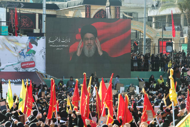  Supporters of Lebanon's Hezbollah leader Sayyed Hassan Nasrallah listen to him as he addresses them through a screen during a rally marking Muharram, a period of mourning for Shi'ite Muslims around the world, in Nabatiyeh, southern Lebanon August 1, 2023. (photo credit: AZIZ TAHER/REUTERS)
