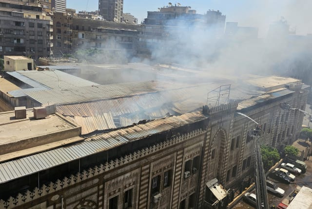  Smoke rises as Egyptian firefighters extinguish a fire that broke out in the historic neo-Islamic ministry in central Cairo, Egypt, August 5, 2023. (photo credit: REUTERS/Patrick Werr)