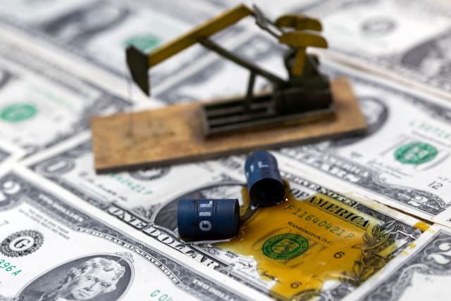 Oil, miniatures of oil barrels, oil pump jack and U.S. dollar banknote are seen in this illustration taken, June 6, 2023. (photo credit: DADO RUVIC/REUTERS)