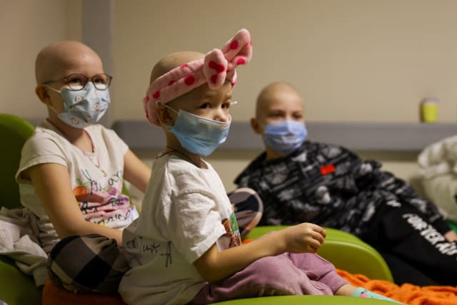  Children patients whose treatments are underway sit on chairs moved to the hallways of basement floors of Okhmadet Children's Hospital, as Russia's invasion of Ukraine continues, in Kyiv, Ukraine February 28, 2022. (photo credit: UMIT BEKTAS/REUTERS)