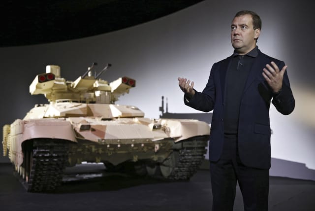  Russia's Dmitry Medvedev speaks during a presentation of the BMPT-72 tank, dubbed the "Terminator-2" (photo credit: REUTERS)