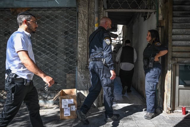  Police at the scene of where a body was found at an apartment in Haifa, August 9, 2023. (photo credit: FLASH90)