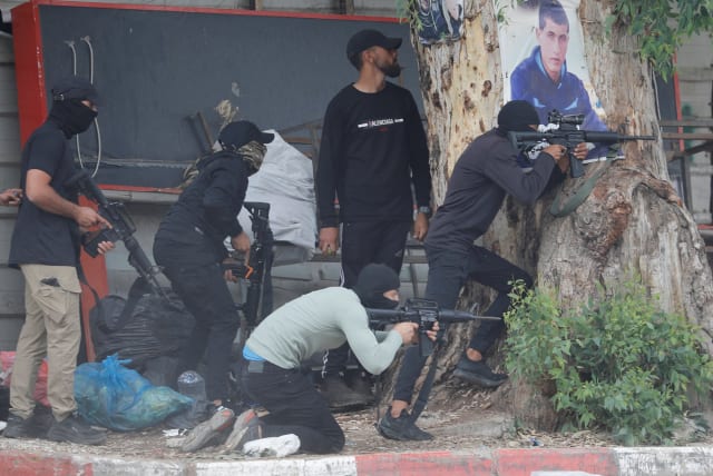  Palestinian gunmen clash with Israeli troops during an Israeli raid in Jenin, in the West Bank June 19, 2023.  (photo credit: RANEEN SAWAFTA/REUTERS)