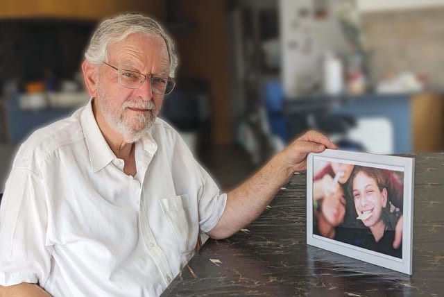  ARNOLD ROTH holds a photo of Malki and her friends at a picnic in Jerusalem’s Old City during the final year of his daughter’s life, a photo he developed from a disposable camera that he discovered after her death. (photo credit: Courtesy Arnold Roth)