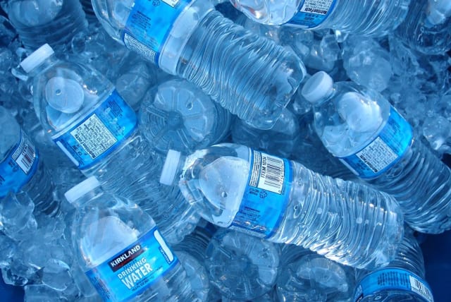 A pile of bottled drinking water with blue labels.  (photo credit: FLICKR)