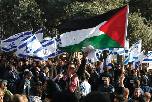  STUDENTS HOLD Palestinian and Israeli flags during a protest at Hebrew University in Jerusalem against Israel’s offensive in Gaza in 2008.  (photo credit: NIKOLA SOLIC/REUTERS)