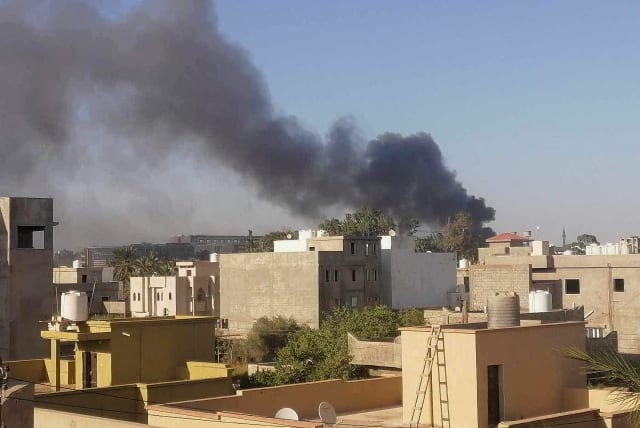  Smoke rises amid clashes between armed factions, in Tripoli, Libya August 15, 2023. (photo credit: REUTERS/STRINGER)
