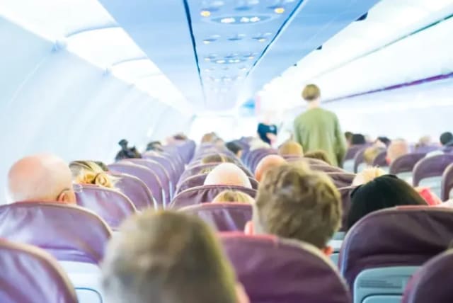  Passengers on an airplane are seated in rows. (photo credit: MAARIV)