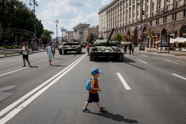 People attend an exhibition displaying destroyed Russian military vehicles located on the main street Khreshchatyk as part of the upcoming celebration of the Independence Day of Ukraine, amid Russia's invasion, in central Kyiv, Ukraine August 21, 2023. (photo credit: GLEB GARANICH/REUTERS)