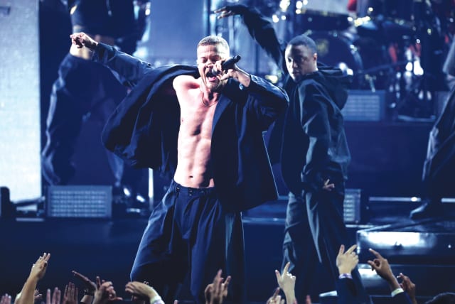  DAN REYNOLDS of Imagine Dragons performs during the 2022 American Music Awards, at the Microsoft Theater in Los Angeles last November.  (photo credit: MARIO ANZUONI/REUTERS)