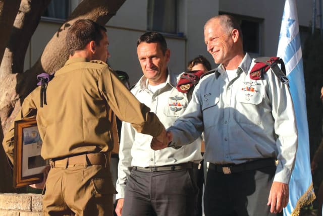  IDF Cheif of Staff Lt.-Gen. Herzi Halevi looks on as the writer receives a citation of excellence for his reserve duty, shaking hands with Brig.-Gen Benny Ben Ari, commander of the Reserve Forces Corps, at a ceremony earlier this year. (photo credit: IDF SPOKESPERSON'S UNIT)