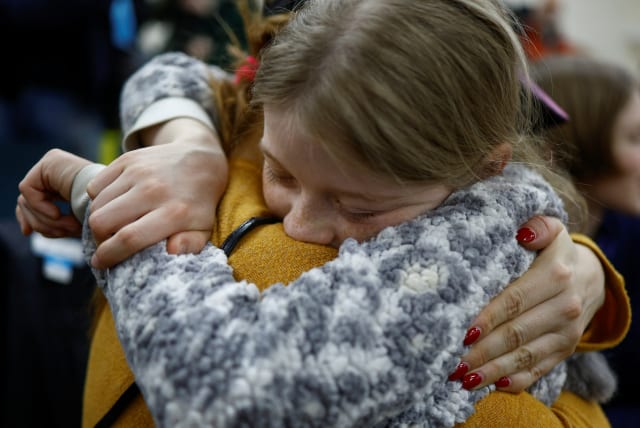  Valeriia, who went to a Russian-organized summer camp from non-government controlled territories and was then taken to Russia, embraces her mother Anastasiia after returning via the Ukraine-Belarus border, in Kyiv, Ukraine April 8, 2023. (photo credit: REUTERS/VALENTYN OGIRENKO)
