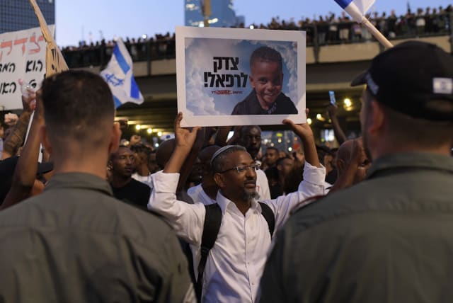  Members of the Ethiopian community and activists block the Ayalon Highway in Tel Aviv during a protest for justice to 4-year-old Rafael Adana, who was run over and killed in a car accident in Netanya, in Tel Aviv, August 23, 2023 (photo credit: TOMER NEUBERG/FLASH90)