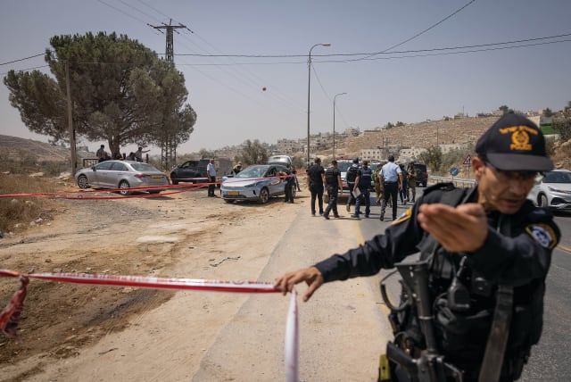  ISRAELI PERSONNEL secure the scene of Monday’s terrorist shooting attack on Highway 60, near Hebron. (photo credit: CHAIM GOLDBEG/FLASH90)