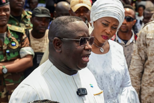 Sierra Leone's President and ruling party candidate Julius Maada Bio speaks to journalists after casting his vote for national elections at a polling station in Freetown, Sierra Leone, June 24, 2023. (photo credit: REUTERS/Cooper Inveen)