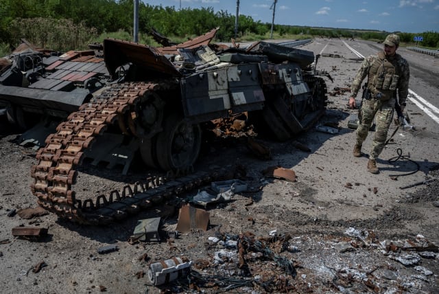  A Ukrainian serviceman walks near a destroyed Ukrainian tank, as Russia's attack on Ukraine continues, near the village of Robotyne, Zaporizhzhia region, Ukraine August 25, 2023.  (photo credit: REUTERS/Viacheslav Ratynskyi)