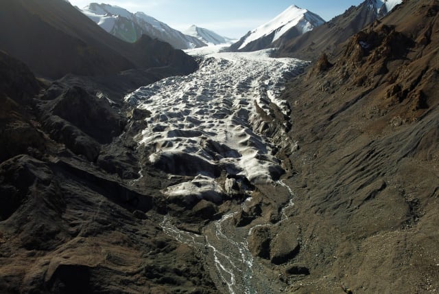  Meltwater from the Laohugou No. 12 glacier, flows though the Qilian mountains, Subei Mongol Autonomous County in Gansu province, China, September 27, 2020 (photo credit: REUTERS/CARLOS GARCIA RAWLINS)