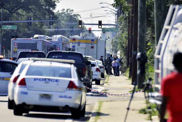 Emergency personnel surround a Dollar General store after a white man armed with a high-powered rifle and a handgun killed three Black people before shooting himself, in what local law enforcement described as a racially motivated crime in Jacksonville, Florida, US. August 26, 2023 (photo credit: Bob Self/USA Today Network via REUTERS)