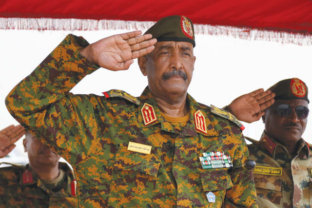  SUDAN’S GENERAL Abdel Fattah al-Burhan salutes for the national anthem after landing in the military airport of Port Sudan on Sunday, on his first trip away from Khartoum since the internal conflict broke out.  (photo credit: Ibrahim Mohammed Ishak/Reuters)