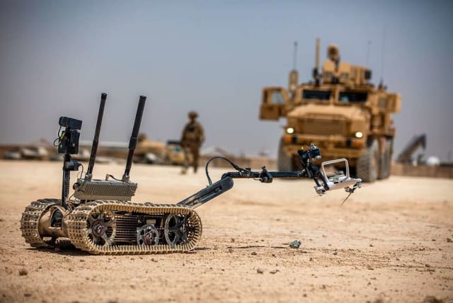  A TALON tracked military robot picks up a downed unmanned aerial system at Al Asad Air Base, Iraq, May 19, 2020. (U.S. Army photo by Spc. Derek Mustard) (photo credit: PICRYL)