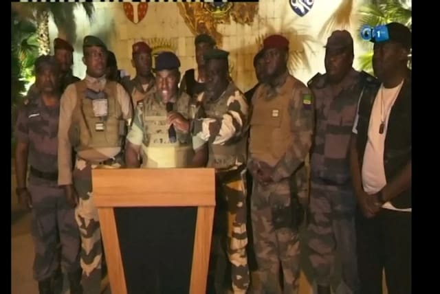  Gabonese military appear on television as they announce that they have seized power following President Ali Bongo Ondimba's re-election, in this screengrab obtained by Reuters on August 30, 2023.  (photo credit: Gabon 1ere/Handout via REUTERS)