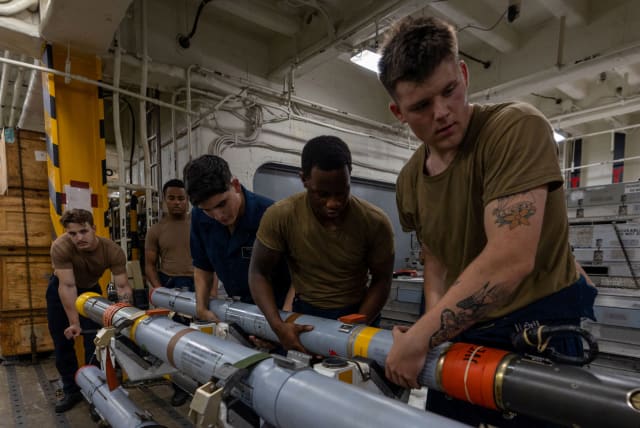  The amphibious assault ship USS Bataan's (LHD-5) Weapons Department Sailors assemble a missile, while under the command and control of Task Force 51/5 on a scheduled deployment to the U.S. 5th Fleet area of operations to help ensure maritime security and stability in the Middle East region. (photo credit: US NAVAL FORCES CENTRAL COMMAND/US 5TH FLEET/HANDOUT VIA REUTERS)