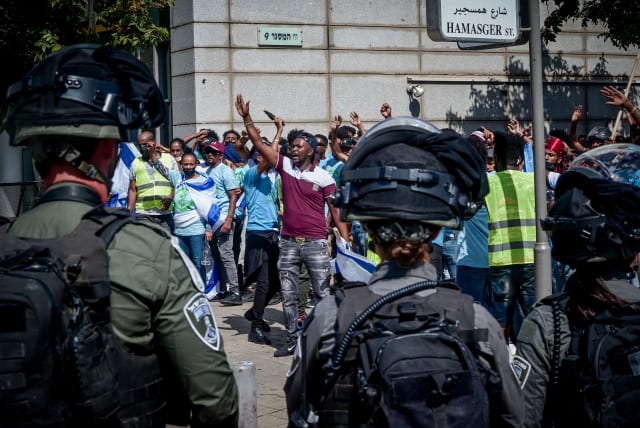 Police guard while Eritrean asylum seekers who oppose the regime in Eritrea protest outside a conference of regime supporters in south Tel Aviv, September 2, 2023 (photo credit: AVSHALOM SASSONI/FLASH90)