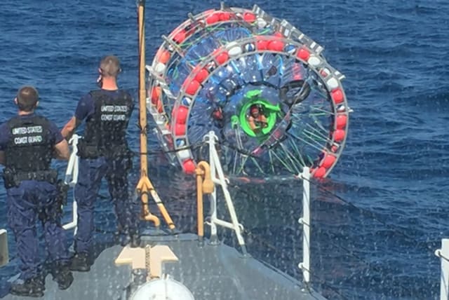   U.S. Coast Guard crews stopped Reza Baluchi (seen sticking his head out of his bubble craft) during his journey from Florida to Bermuda on Sunday, April 25th, 2016. (photo credit: VIA WIKIMEDIA COMMONS)