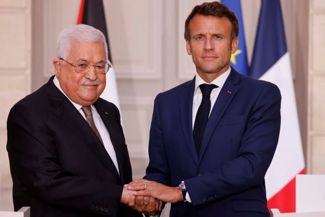  French President Emmanuel Macron welcomes Palestinian President Mahmoud Abbas before a meeting at the Elysee Presidential Palace in Paris, France July 20, 2022 (photo credit: LUDOVIC MARIN/POOL VIA REUTERS)