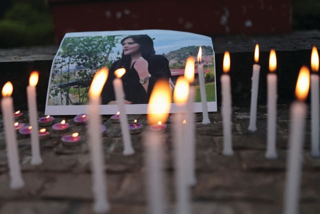  A PHOTO OF Mahsa Amini is pictured at a vigil of students and activists from Delhi University in New Delhi, India, last September following her death.  (photo credit: REUTERS/ANUSHREE FADNAVIS)