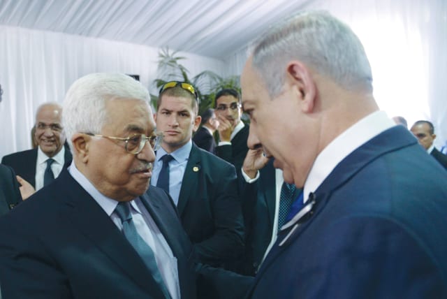  PRIME MINISTER Benjamin Netanyahu shakes hands with PA head Mahmoud Abbas at the funeral of Shimon Peres, in Jerusalem, 2016. The Oslo process has been continued by every government including by Benjamin Netanyahu, says the writer.  (photo credit: AMOS BEN-GERSHOM/GPO)