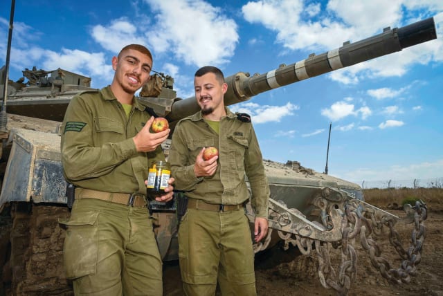  SOLDIERS ARE equipped with apples and a jar of honey to mark Rosh Hashanah. (photo credit: MICHAEL GILADI/FLASH90)