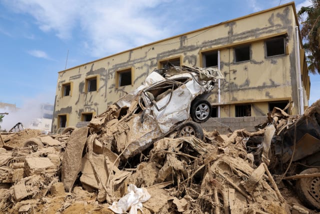  A destroyed car sits on top of a pile of rubble, following fatal floods in Derna, Libya, September 17, 2023REUTERS/Amr Alfiky (photo credit: REUTERS/AMR ALFIKY)