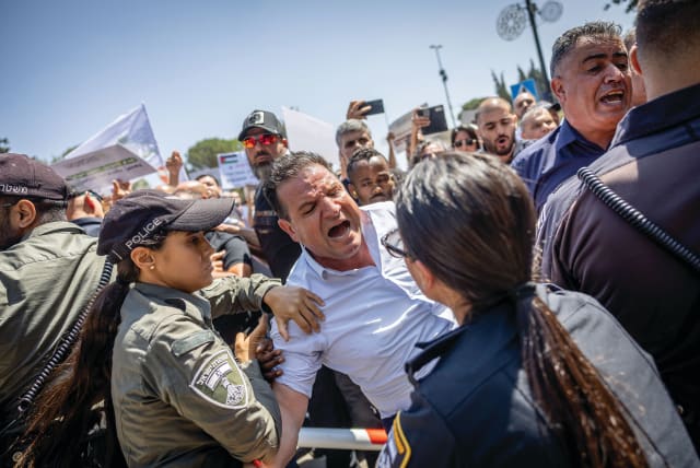  MK AYMAN ODEH is involved in a confrontation with police at a protest outside the Finance Ministry in Jerusalem in August, after Finance Minister Bezalel Smotrich initially froze funds to Arab local councils.  (photo credit: YONATAN SINDEL/FLASH90)