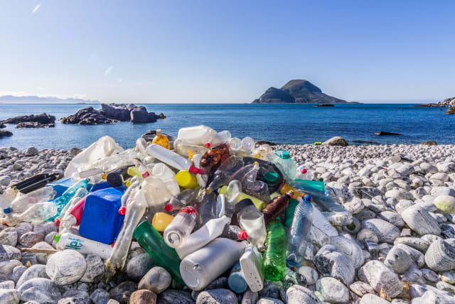  Plastic bottles on a beach, illustrative (photo credit: Flickr/Bo Eide)