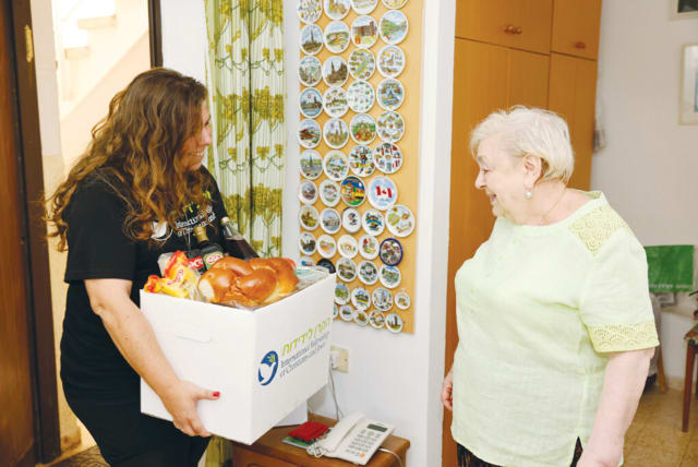  FAINA RECEIVES food and support for the holidays.  (photo credit: GUY YECHIELI)