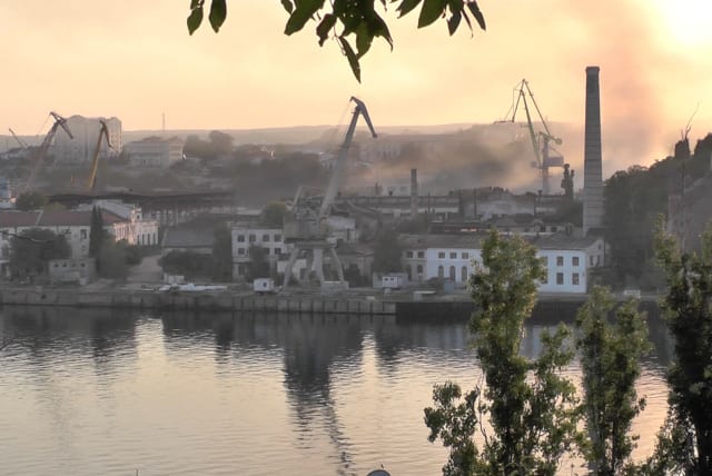  Smoke rises from the shipyard that was reportedly hit by Ukrainian missile attack in Sevastopol, Crimea, in this still image from video taken September 13, 2023. (photo credit: REUTERS TV via REUTERS)