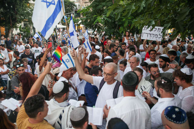  Jews pray while activists protest against gender segregation in the public space during a public prayer on Dizengoff Square in Tel Aviv, on Yom Kippur, the Day of Atonement, and the holiest of Jewish holidays, September 25, 2023. (photo credit: ITAI RON/FLASH90)