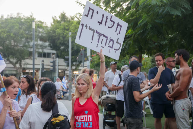  Jews pray while activists protest against gender segregation in the public space during a public prayer on Dizengoff Square in Tel Aviv, on Yom Kippur, the Day of Atonement, and the holiest of Jewish holidays, September 25, 2023.  (photo credit: ITAI RON/FLASH90)