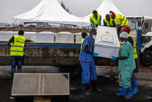  Workers carry the coffin of a protestor killed during a demonstration before burial at the Makao cemetery in Goma, North Kivu province, Democratic Republic of the Congo September 18, 2023.  (photo credit: REUTERS/Arlette Bashizi)