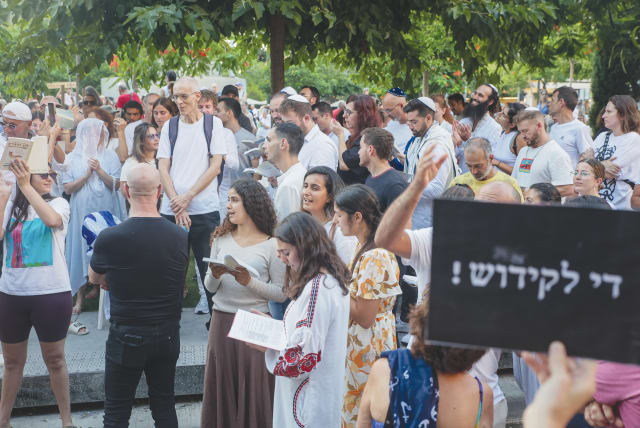  JEWS PRAY while activists protest against gender segregation in the public space during a public prayer at Dizengoff Square in Tel Aviv, on Yom Kippur last week. (photo credit: ITAI RON/FLASH90)