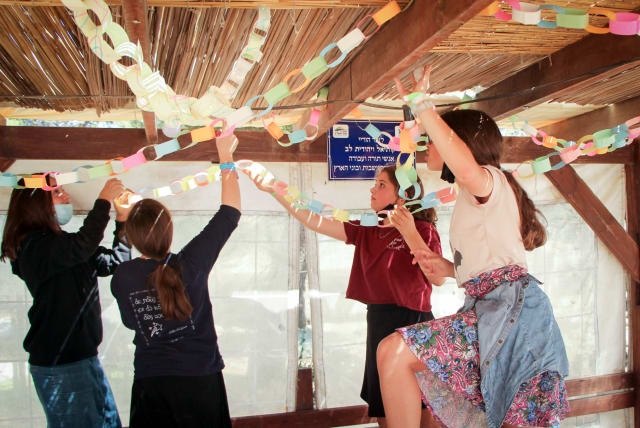  SUKKOT DECORATIONS, much as we love them, eventually need to be packed up (photo credit: GERSHON ELINSON/FLASH90)