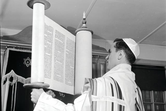  FRESH EYES: Lifting a Torah scroll at Yeshiva University in New York, 1950.  (photo credit: Al Barry/Three Lions/Getty Images)